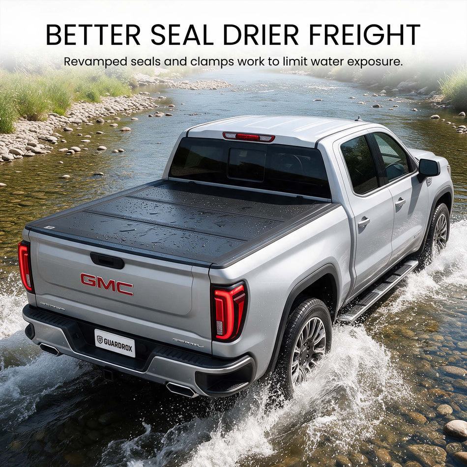 Waterproof hard tri-fold truck bed cover with full-perimeter seals fording a shallow stream