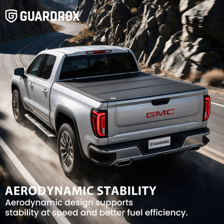 Hard truck bed cover riding steady on a pickup cruising a mountain highway for better fuel economy