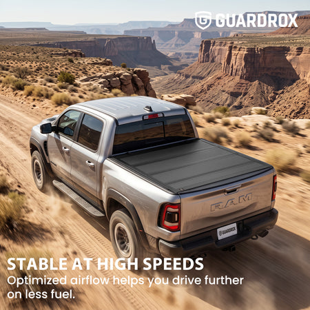 Hard quad-fold tonneau cover riding steady on a RAM 1500 cruising a mountain highway for better fuel economy