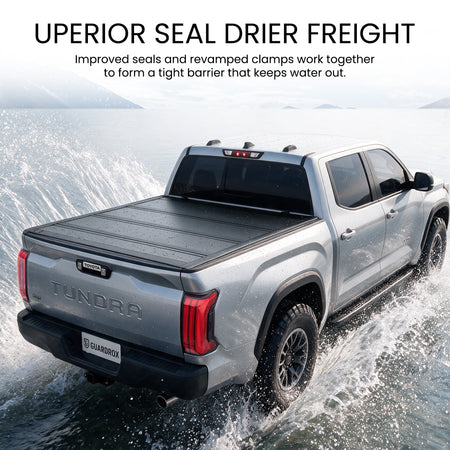 Waterproof hard quad-fold tonneau cover with full-perimeter seals fording a shallow stream