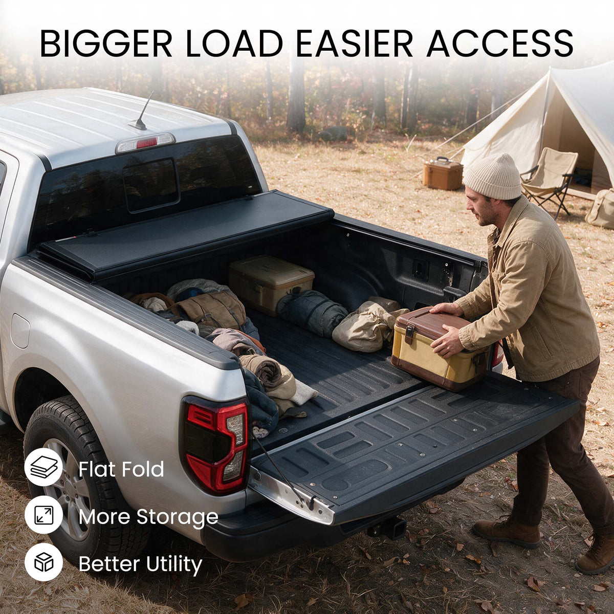 Folding truck bed cover propped open with firewood, skis, and duffels loaded in a snowy pickup bed