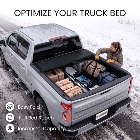 Chevy Silverado 1500 bed with the L6 cover fully folded against the cab and loaded with bulky cargo