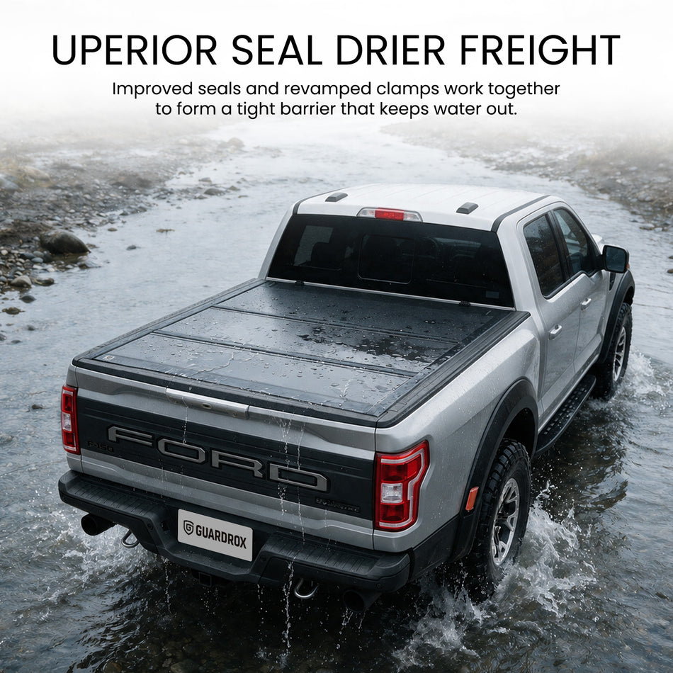 Waterproof hard tri-fold truck bed cover with full-perimeter seals in heavy rain