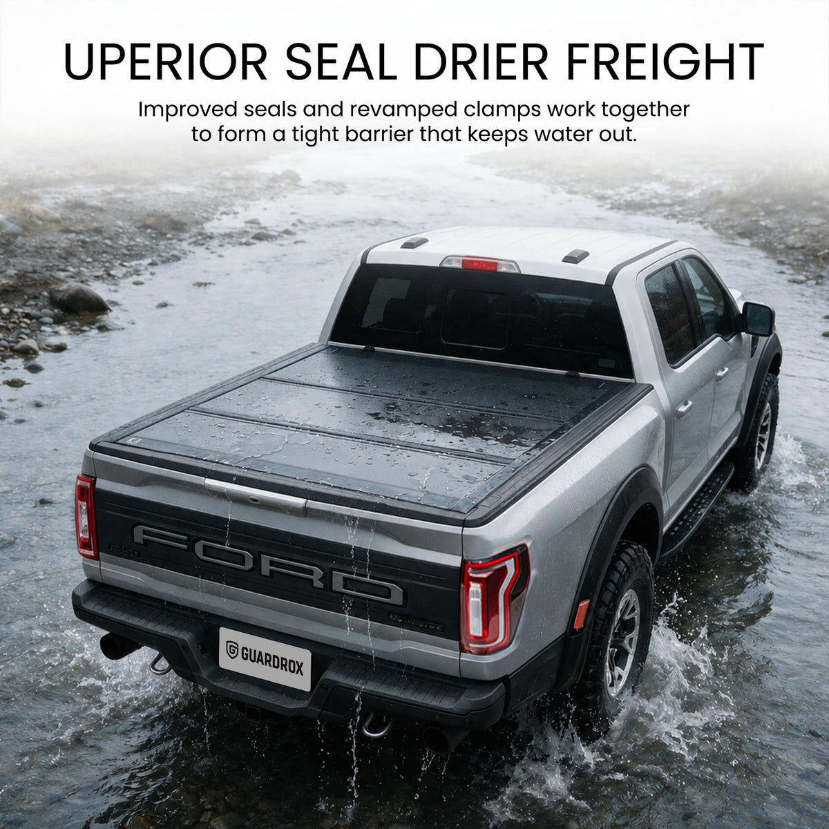 Waterproof hard tri-fold truck bed cover with full-perimeter seals fording a shallow stream