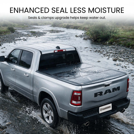 Waterproof hard tri-fold truck bed cover with full-perimeter seals fording a shallow stream