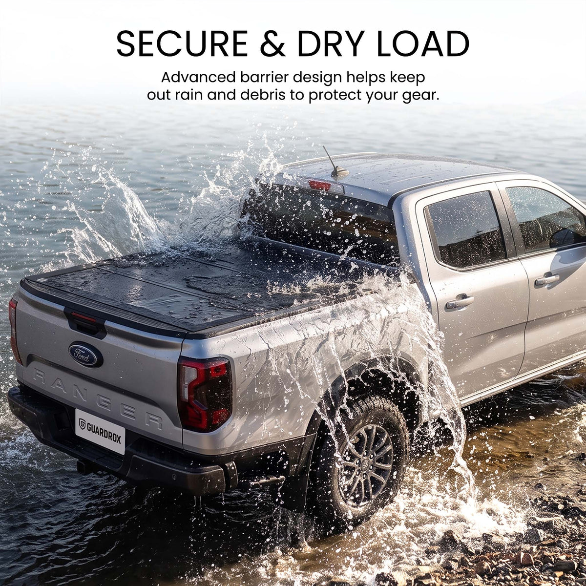 Waterproof hard tri-fold truck bed cover with full-perimeter seals fording a shallow stream