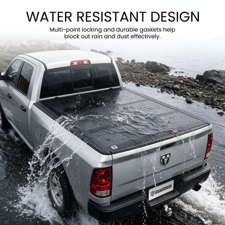 Waterproof hard tri-fold truck bed cover with full-perimeter seals fording a shallow stream