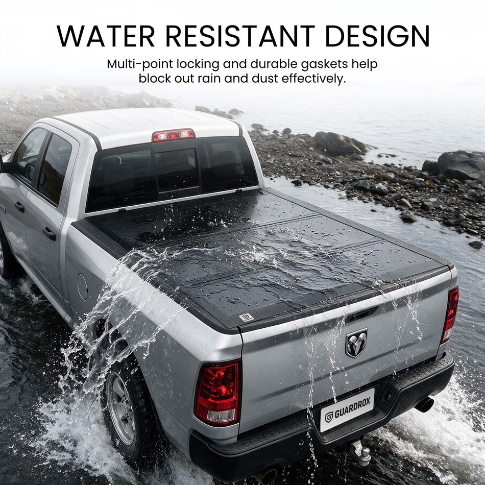Waterproof hard tri-fold truck bed cover with full-perimeter seals fording a shallow stream