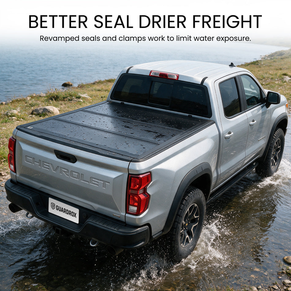 Waterproof hard tri-fold truck bed cover with full-perimeter seals fording a shallow stream
