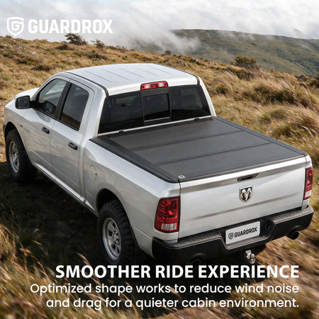 Hard truck bed cover riding steady on a pickup cruising a mountain highway for better fuel economy