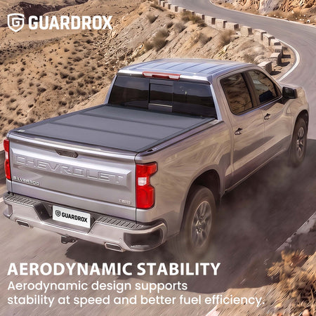 Hard truck bed cover riding steady on a pickup cruising a mountain highway for better fuel economy